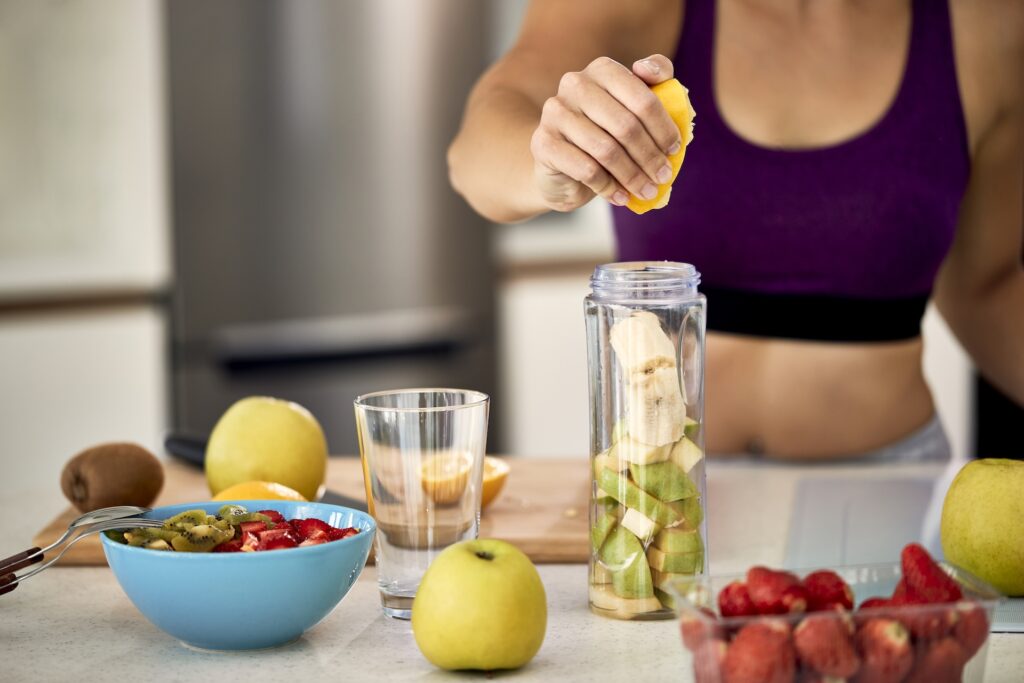 close up of sportswoman using lemon while making f 2024 12 13 21 56 17 utc